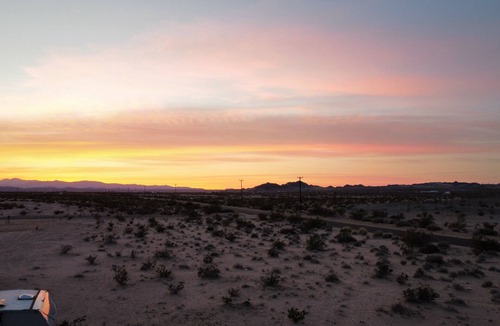 Wonder Valley RV Rental | RV space with fire pit under the stars